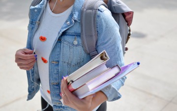 student holding books