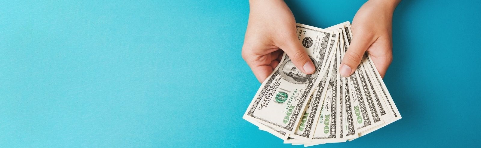 hands holding money with blue background