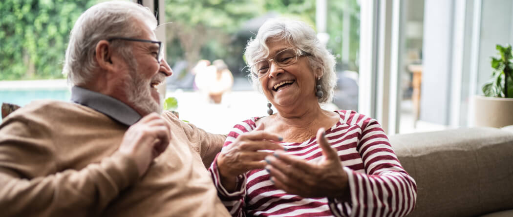 Mature couple talking on a couch