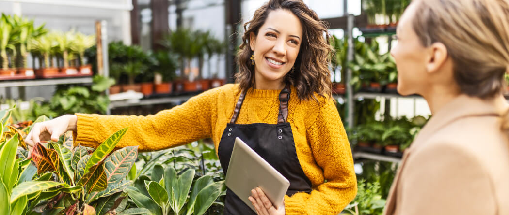 Worker and customer talking in a plant nursery 