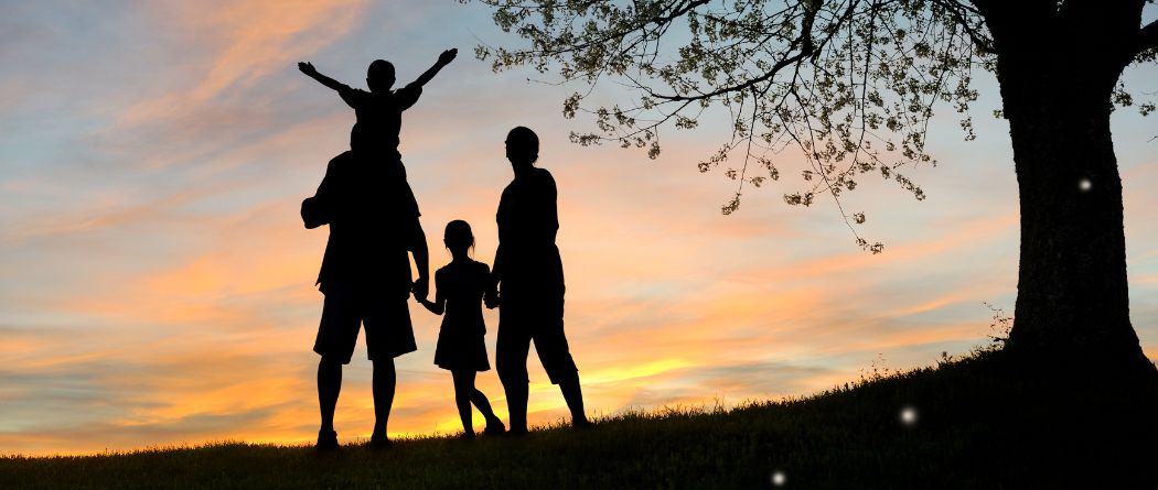 family spending time in sunset