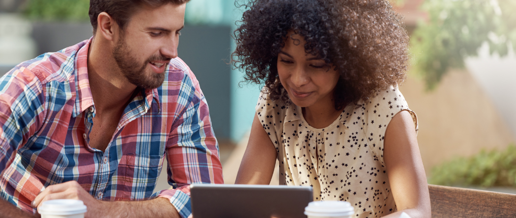 man and woman talking over tablet