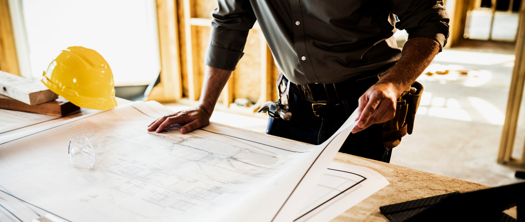 construction man looking at blueprint