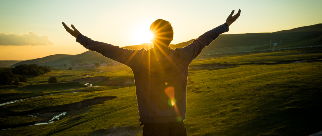 person in front of mountain sunset