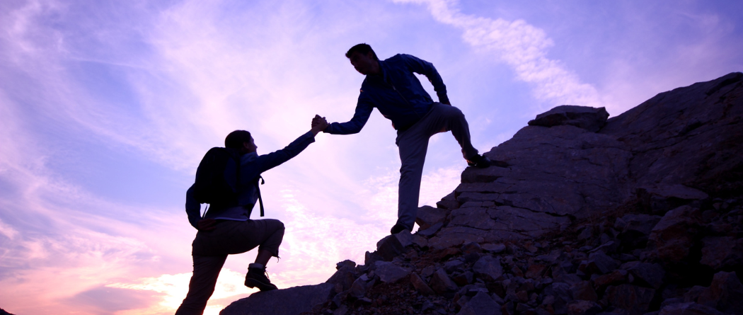 people climbing mountain together