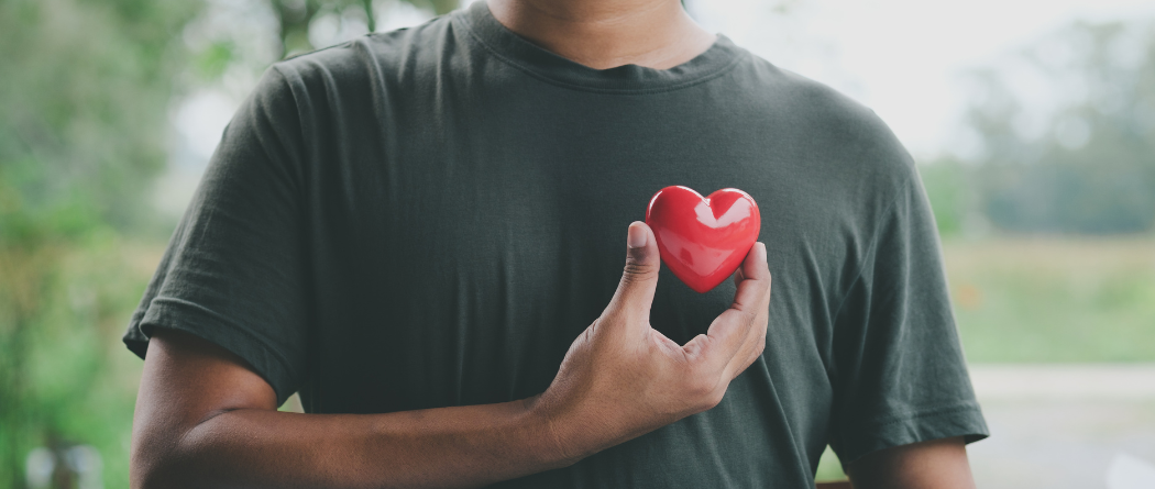 man holding heart statue